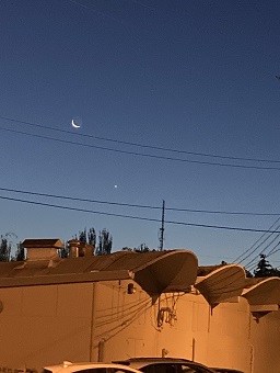 crescent moon above building
